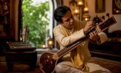 Rajib Karmakar sitarrajib Sitar Performance Technical Requirements: 2026 Guide 1 Sitar performer tuning instrument on stage setup