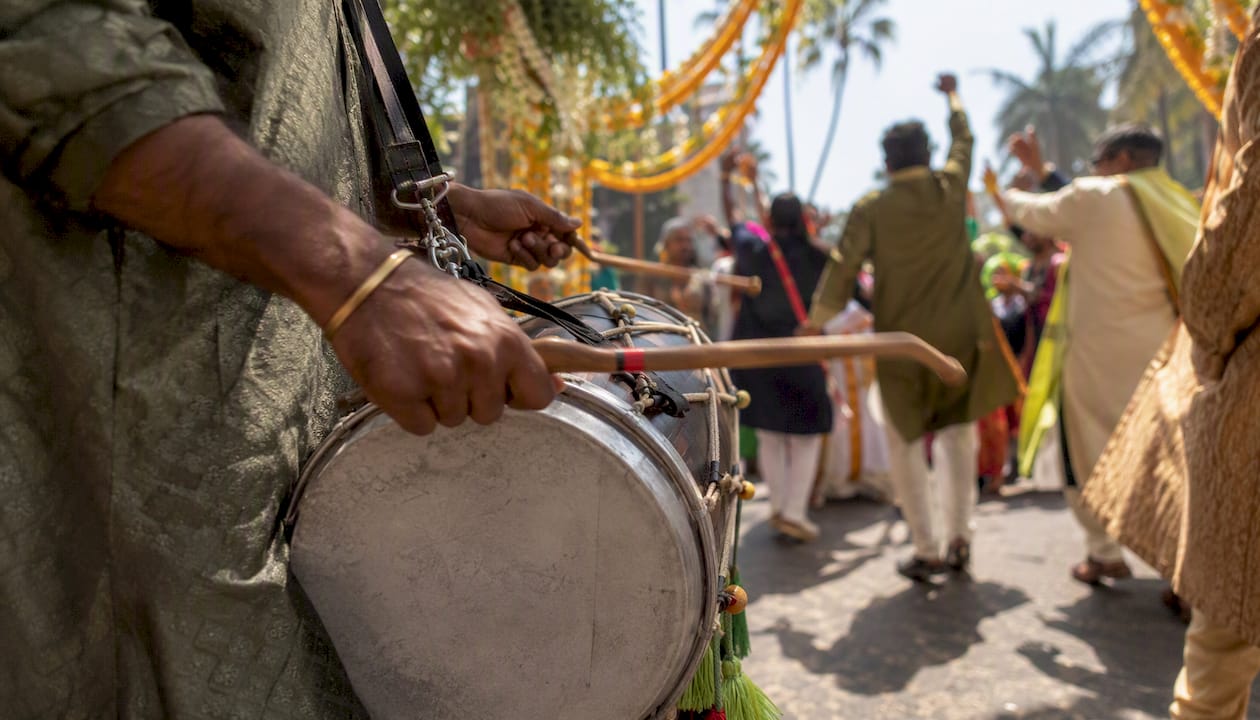Rajib Karmakar sitarrajib Baraat Music Ideas: High-Energy Playlists & DJ Tips 1 Dhol player drumming at baraat procession