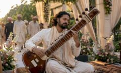 Sitar player performing seated at wedding ceremony