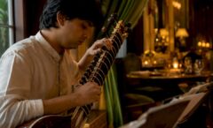 Sitarist tuning sitar strings in gala venue