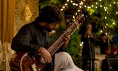 Sitarist playing sitar in jazz fusion concert
