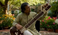 Sitarist tuning sitar for TV music pitch