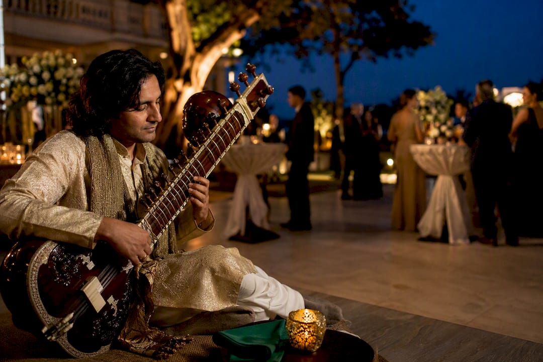 Rajib Karmakar sitarrajib Planners' Playbook: Book Live Music for Receptions With Sitar 1 Sitarist performing at an elegant reception