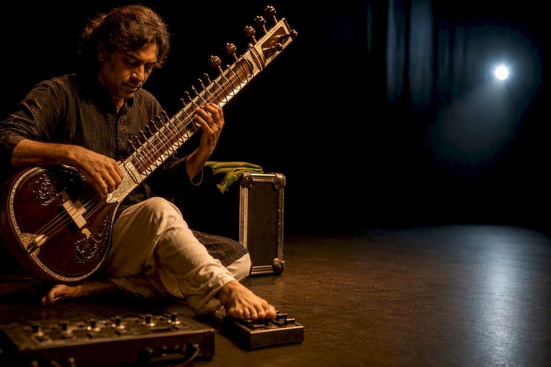 Sitarist layering live loops onstage