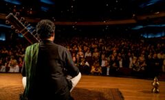 Sitarist scanning audience before concert
