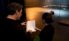 Venue team reviewing performance rider backstage