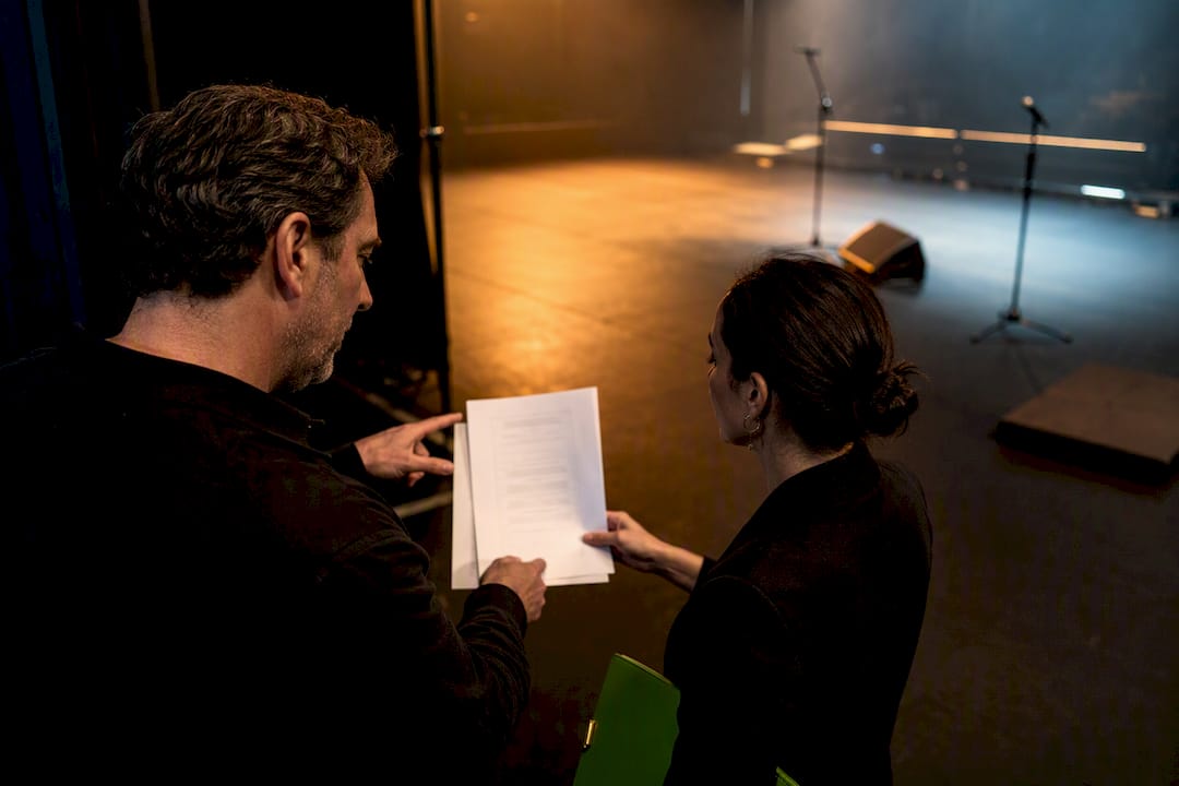 Venue team reviewing performance rider backstage