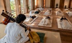 Sitarist performing for reclining sound bath listeners
